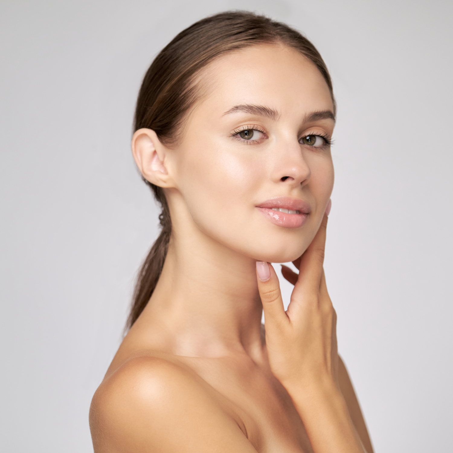 Beautiful Beauty and face care concept - Beautiful Young Woman with Clean Fresh Skin standing over light grey background. Young Woman with Clean Fresh Skin standing over light grey background. High quality 4k footage